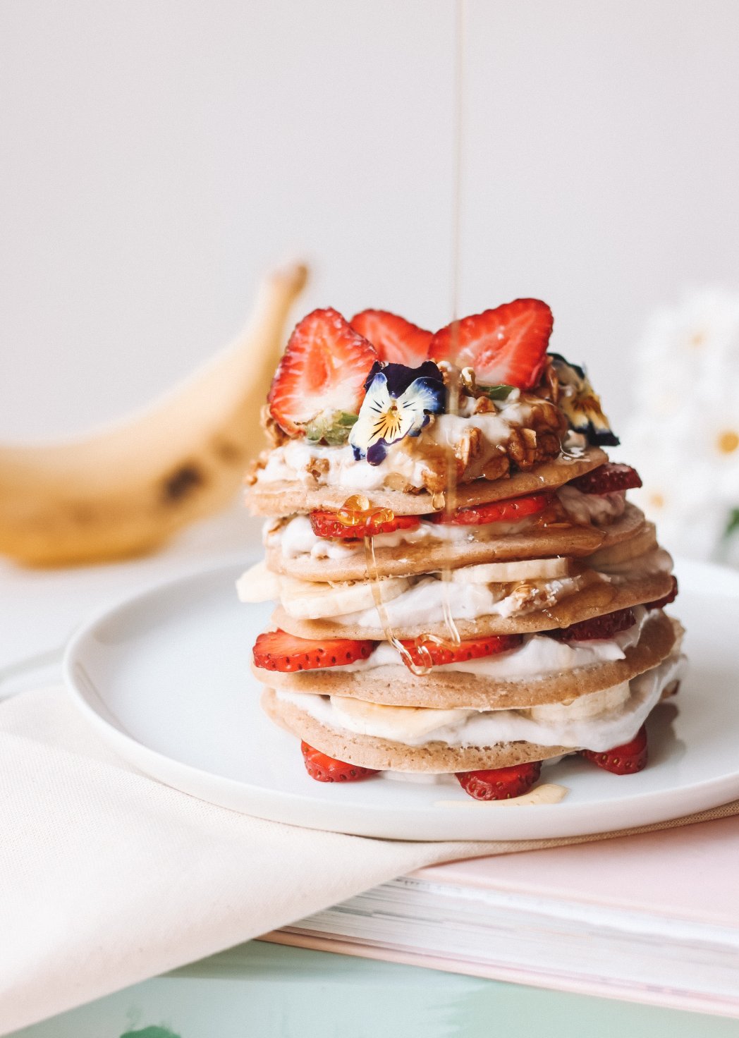 Banana pancakes with cashew butter and strawberries